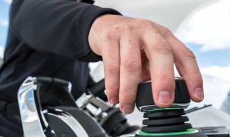 Hand operating a Side Power thruster joystick